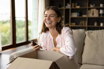 Happy customer unpacking surprising unexpected gift, receiving awaited purchase from internet shop,...