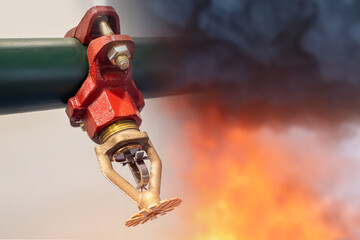 Sprinkler for fire extinguishing system. Sprinkler next to flame and smoke. Concept - equipment for fire fighting. Sprinkler for extinguishing flame in building. Internal fire extinguishing system. - obrazy, fototapety, plakaty