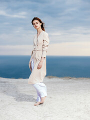 attractive woman in coat sand summer elegant style