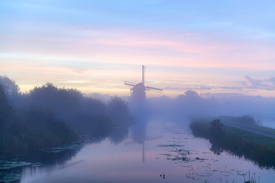 Calm and foggy sunrise morning on the Hazerswouder-Dorp windmill,  Rietveldse, Netherlands.