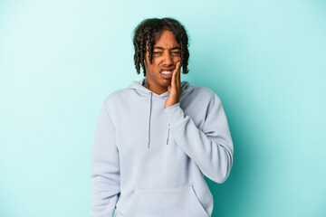 Young african american man isolated on blue background having a strong teeth pain, molar ache.