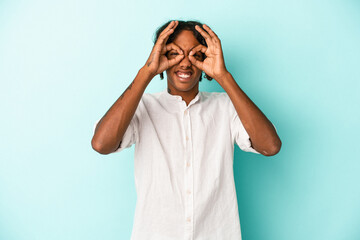 Young african american man isolated on blue background excited keeping ok gesture on eye.