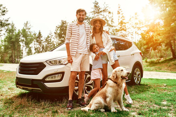 The whole family came to nature for the weekend. Mom and Dad with their daughter and a Labrador dog...