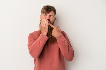 Young caucasian ginger man with long beard isolated on white background having a strong teeth pain,...