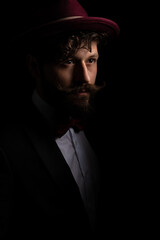 young businessman looking away, wearing a burgundy hat