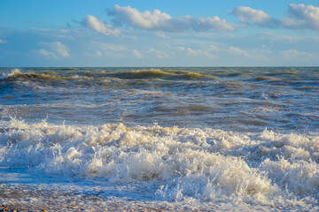 Small storm at sunset, high waves with white foam © Delia_Suvari