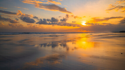 Fototapeta na wymiar Sunset time. Seascape background. Bright sunlight. Sun at horizon line. Scenic view. Sunset golden hour. Sunlight reflection in water. Beautiful nature. Copy space. Kelanting beach, Bali