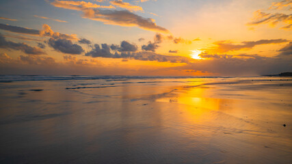 Naklejka na ściany i meble Sunset time. Seascape background. Bright sunlight. Sun at horizon line. Scenic view. Sunset golden hour. Sunlight reflection in water. Magnificent scenery. Copy space. Kelanting beach, Bali