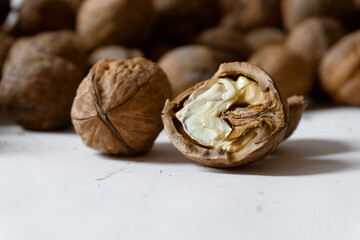 Closeup of a cracked walnut on white background.