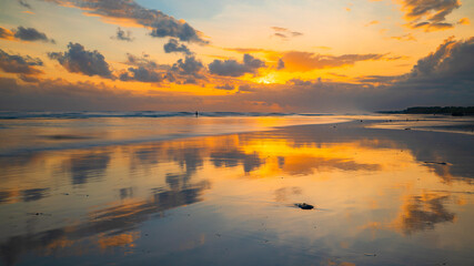 Obraz premium Sunset time. Seascape background. Cloudy sky. Scenic view. Sunset golden hour. Sunlight reflection in water. Magnificent scenery. Beautiful nature. Copy space. Kelanting beach, Bali