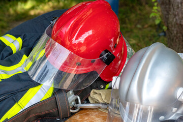 Firefighter uniform with red helmet. Close-up image of a red helmet of a fireman. A  helmet of the...