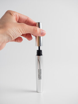 01.05.2021 Russia, Moscow. Kiko mascara on a white background. Women's hands hold the mascara open. A brush for applying mascara. The concept of cosmetics