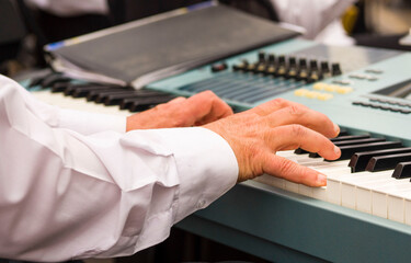 Obraz premium Pianist playing piano.The man plays the piano