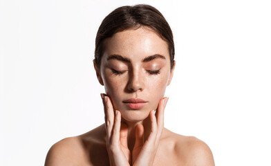 Skin care. Beauty face of young woman with closed eyes, gently touching soft, natural facial skin...