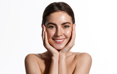 Skin care. Woman with beauty face touching healthy facial skin portrait. Beautiful smiling girl...