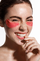 Vertical portrait of woman wearing under eye pink patches, collagen skin care product for...