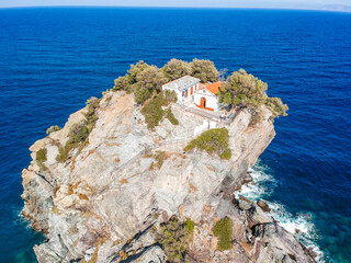 Aerial view of the famous small church Agios Ioannis in Skopelos where scenes of Mamma Mia were filmed. Its located in the region of Kastri, about 7km east of Glossa, northern Skopelos Sporades Greece - obrazy, fototapety, plakaty