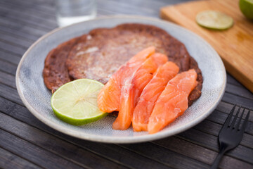 salted salmon fillet with rye pancakes and lime