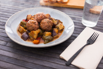 cooked meatballs with stewed eggplant with haze in bowl