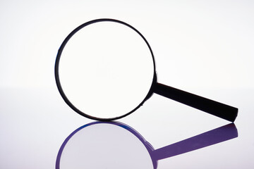 close up of magnifying glass against white background