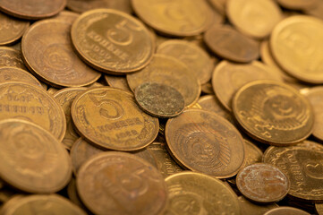 Old coins out of circulation in bulk, background image, close-up, selective focus.