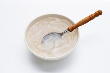 Bowl of sliced toddy palm in syrup on white background.