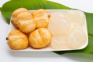 Toddy palm in white plate on green leaf