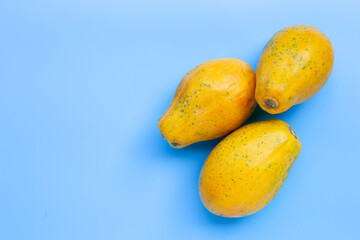 Papaya fruit on blue background.