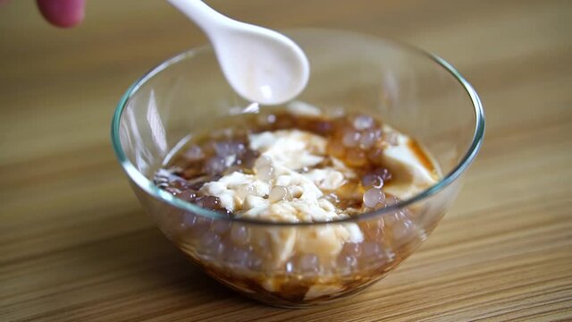 mixing the syrup of hot or cold taho with tapioca pearls