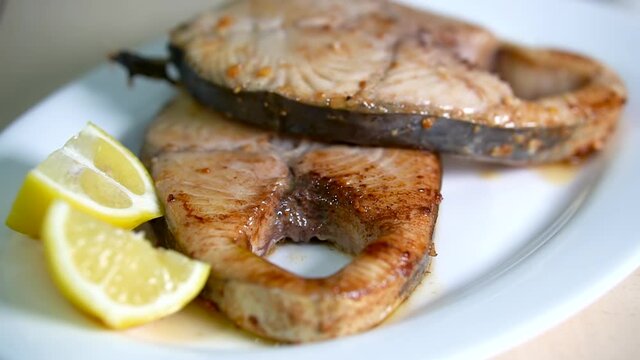 squeezing sliced lemon on fried steak chub mackerel 