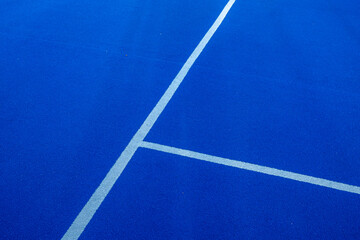 Fototapeta na wymiar Lines, blue paddle tennis court field background