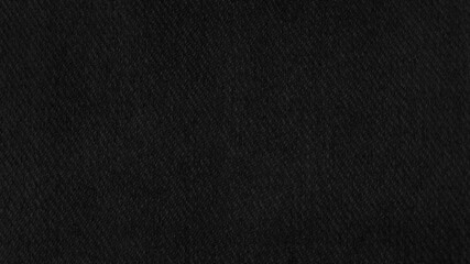 black fabric texture background. close up detail of canvas textile material with blank space for design. dark fabric texture. clothes background.
