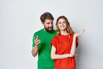 a young couple hug friendship colorful t-shirts family isolated background