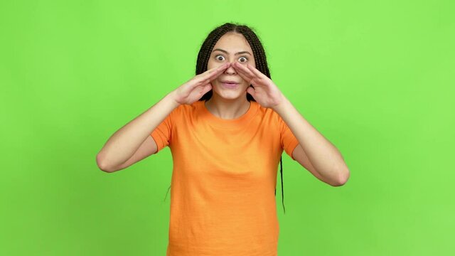 Teenager girl with braids shouting and announcing something over isolated background. Green screen chroma key