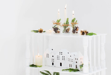 home christmas decor with burning candles in whte interior