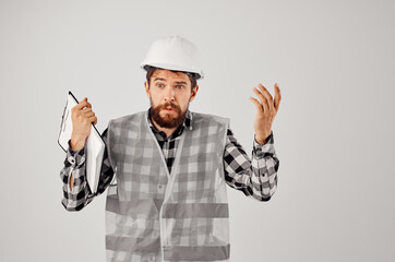 male builder in a white helmet blueprints Professional light background