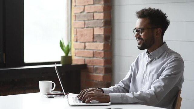 Young handsome man using laptop at home, Businessman or student working online on computer indoors, Freelance, online marketing, distance education, e-learning, home work and lockdown concept