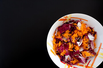 Salad with carrots on black table, top view