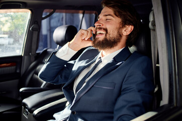 bearded man in a suit in a car a trip to work service