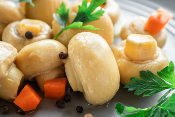 marinated mushrooms in a close-up gray plate