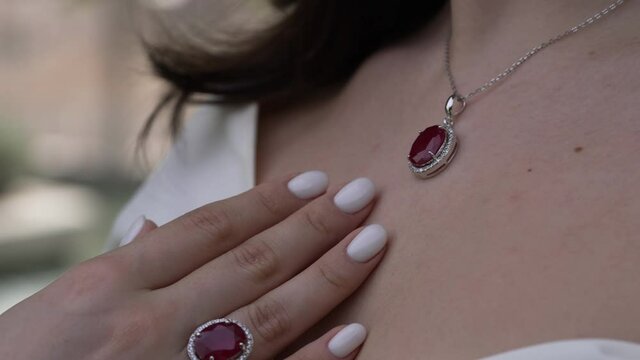 woman with ruby ring and necklace pendant