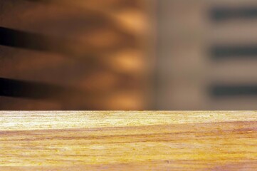 Wooden board empty table in front of soft brown abstract background for display of product