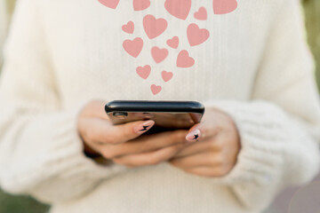 Girl browses social networks via smartphone. The concept of likes on the Internet.