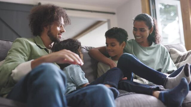 Slow motion of happy family on sofa