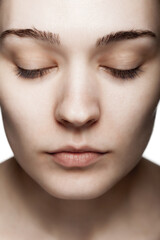 Fototapeta premium close up face studio portrait of a beautiful young woman against white backgroung