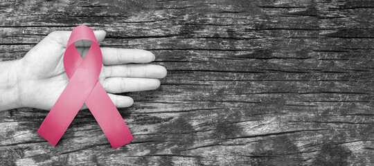 Pink ribbon for breast cancer awareness in October, wear pink day charity for woman health fighting with breast tumor illness (bow isolated with clipping path on white background)