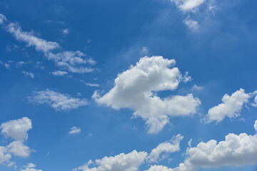 Naklejka na ściany i meble Beautiful white clouds on blue sky background