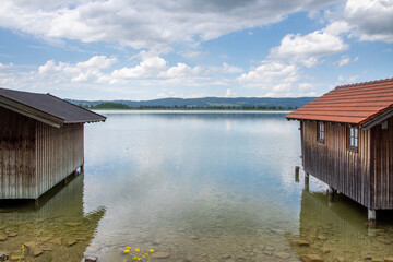 View of the Kochelsee in the south of Bavaria, Germany with boat hats on the right and left