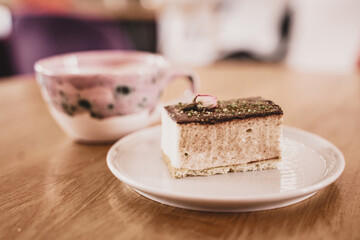 festive cake on a saucer decorated with a rose