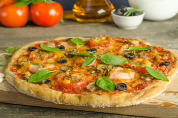 Delicious fresh homemade pizza with ham on wooden background with selective focus